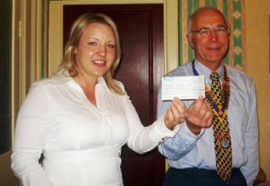 Amy Fitzgeral recives a £250 sponsor cheque from Rotary Club of Buxton President Ian Saunders